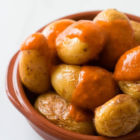 A plate of Papas Arrugadas con Mojo Rojo, a traditional Canarian dish.