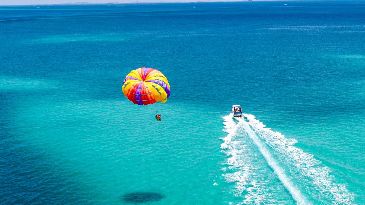 A parasailor and a boat.